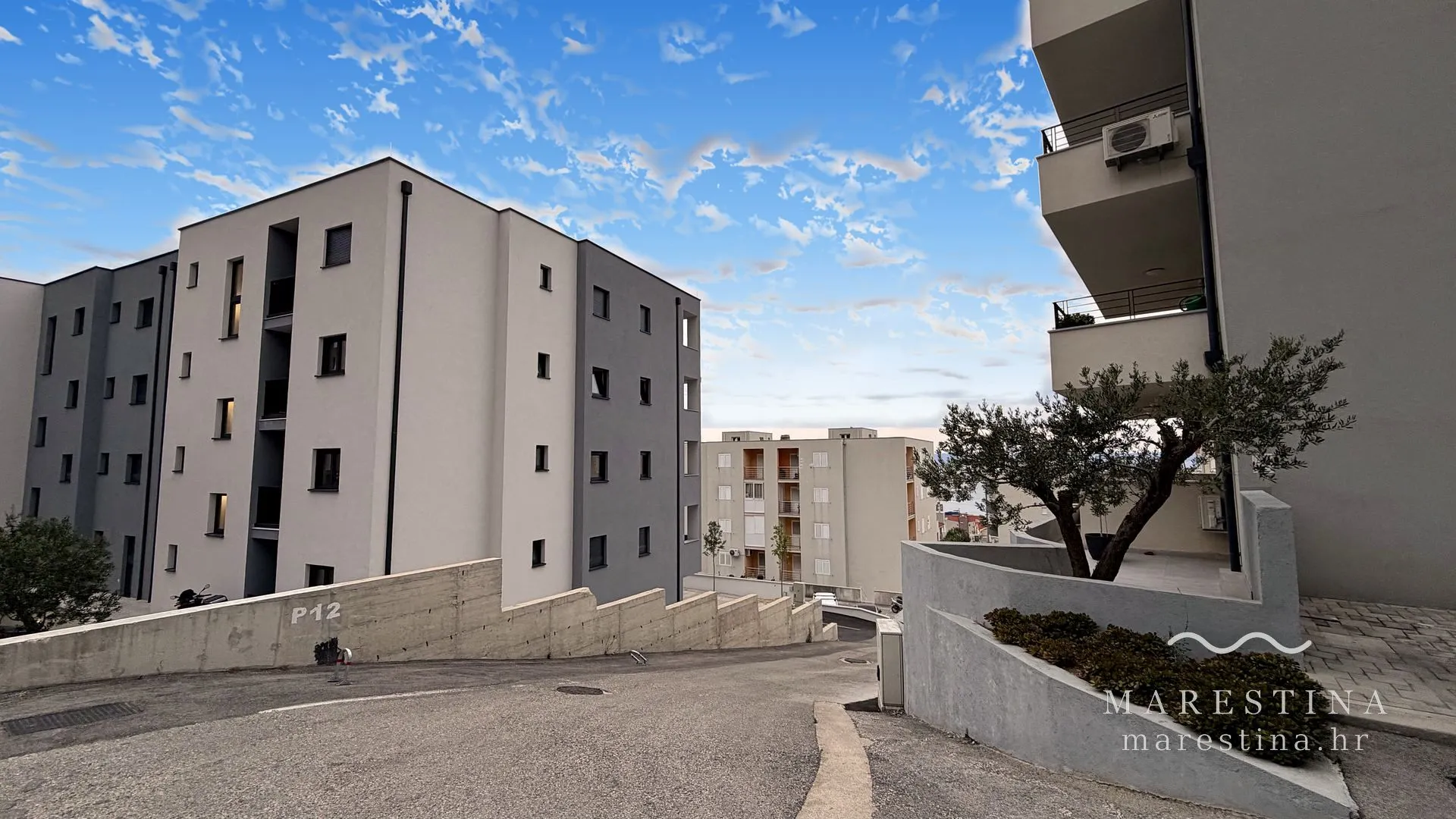 The building entrance and dedicated parking space